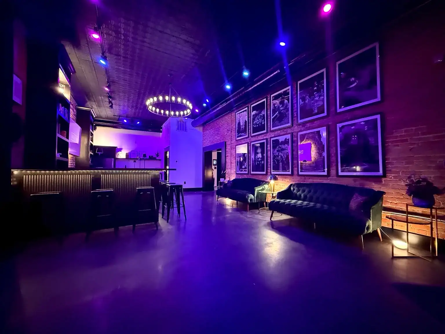 The Dim Light Social lounge and bar illuminated with violet and blue lighting